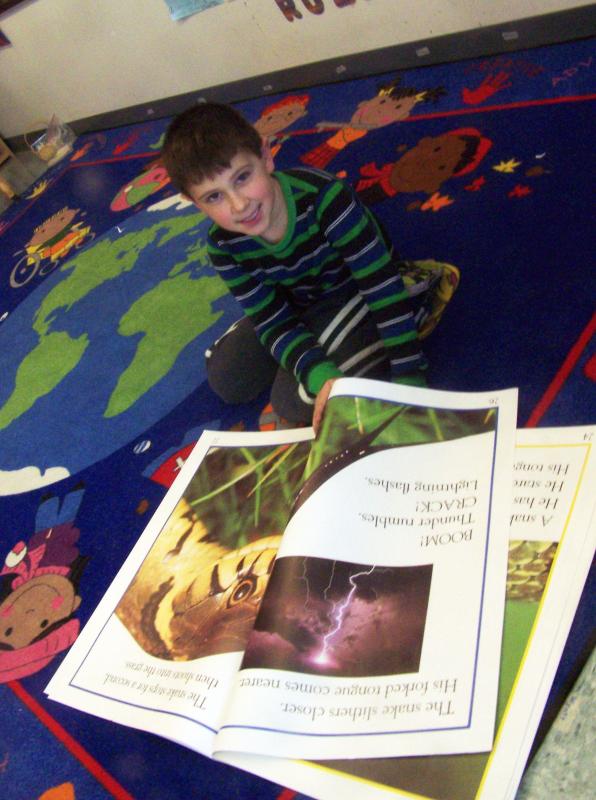 Wyatt Harding relaxes and reads in a Rochester Memorial School kindergarten classroom. This year, all tri-town schools offered a tuition free full-day kindergarten program for the first time. BY MATTHEW BERNAT